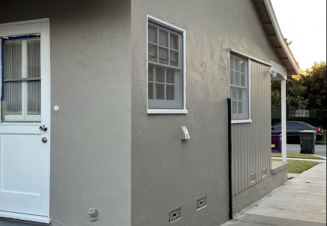 taupe colored stucco paired with a dark gray concrete deck.