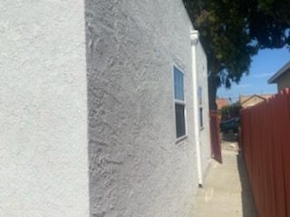 textured stucco painted white.