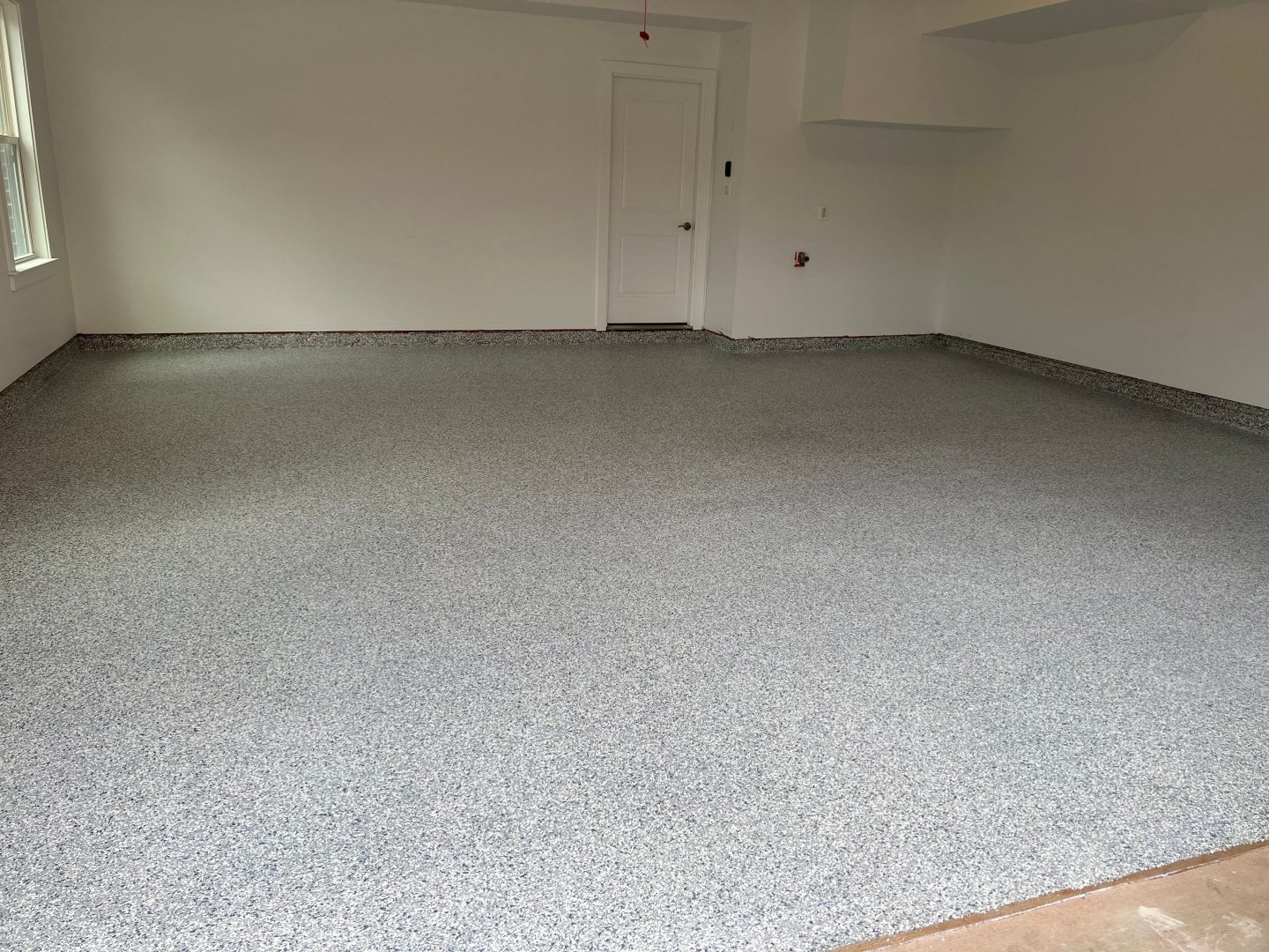 After Photo of granite garage concrete floor with an epoxy finish and repainted wall