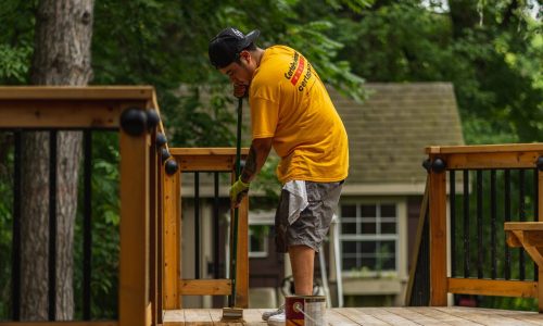 certapro crew member staining a deck