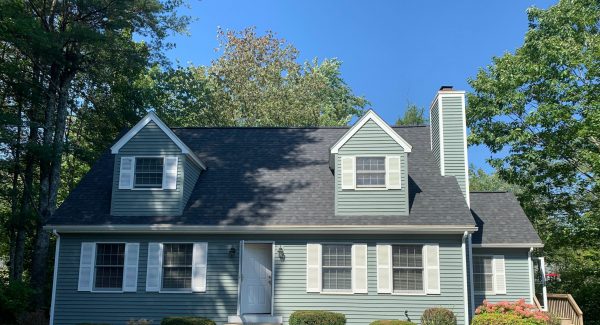 Green and white home after painting