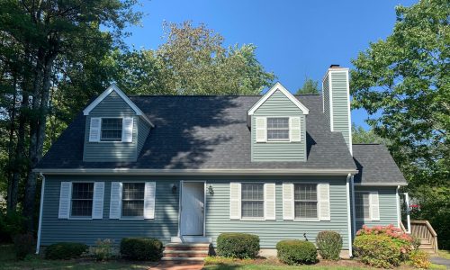 Green and white home after painting