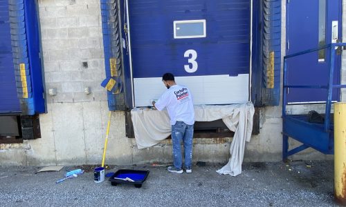 Employee Painting Loading Dock Doors