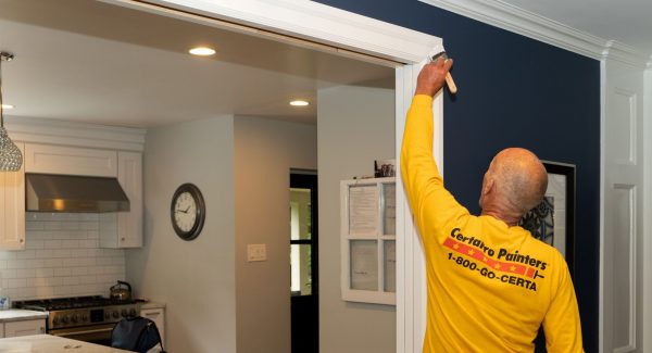 painter painting trim inside home