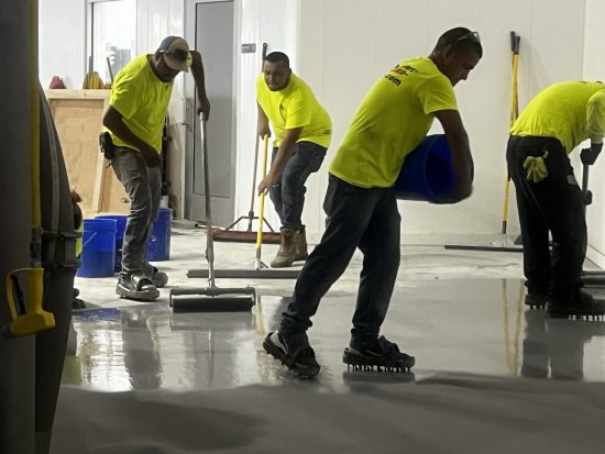 McCarty Farms Commercial Flooring Project spreading the product on the floor