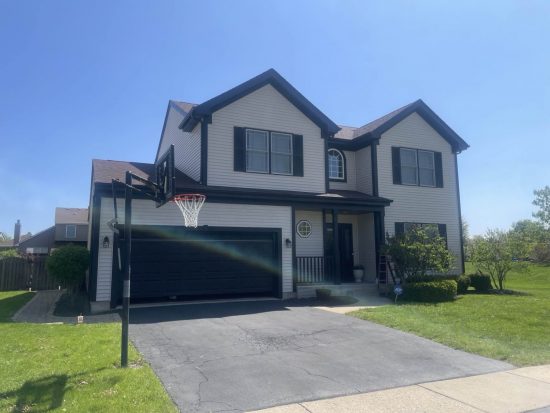 front of house with painted exterior, garage door and trim