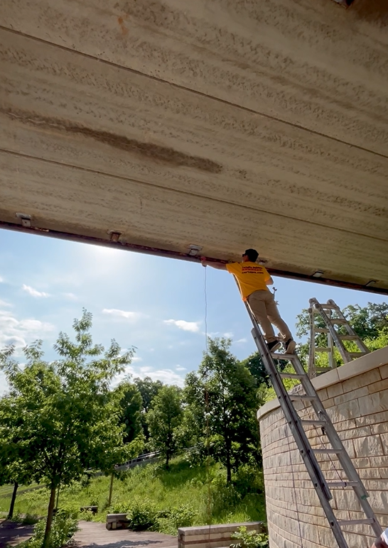 painter on a ladder beneath a footbridge Preview Image 3
