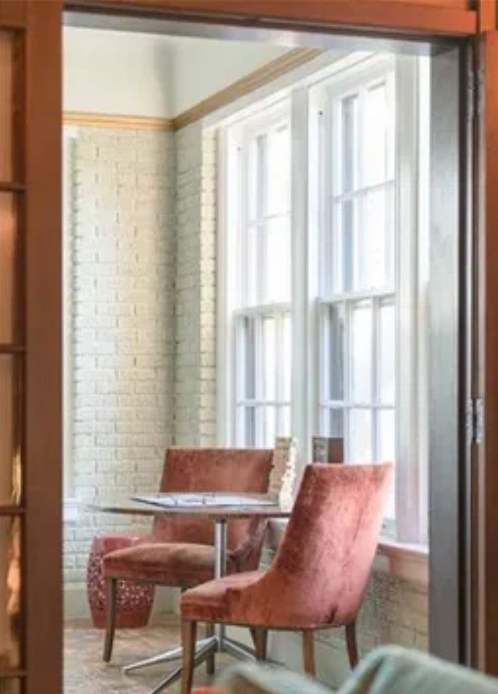 white painted brick room with small table and two chairs Preview Image 7