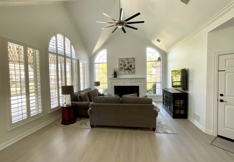 living room with vaulted ceilings and large ceiling fan