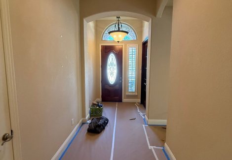 front hallway with protective sheeting for painting