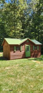 Painted and power washed outdoor shed, viewed from the front