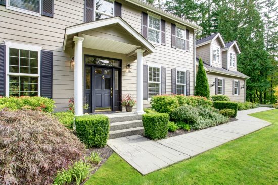brown vinyl siding with white shutters