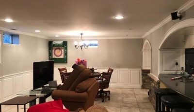full view of the finished basement paint job with gray walls and white ceiling and trim