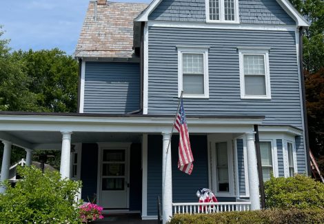 front of house with blue siding and whit trim
