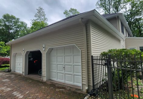 garage side of house with painted vinyl siding
