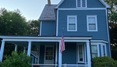front of house with blue siding and whit trim