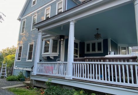 front of house with blue siding and whit trim