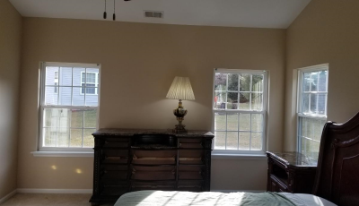 tan painted master bedroom walls with white painted ceiling and trim