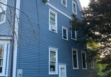front of house with blue siding and whit trim