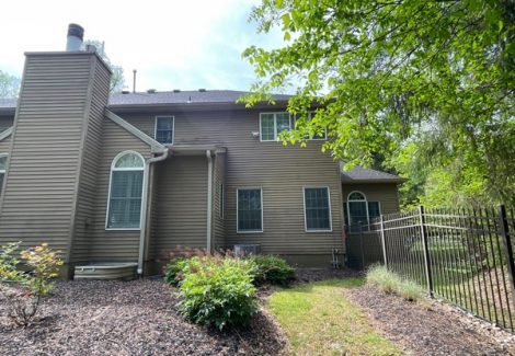 rear exterior of house with brown siding