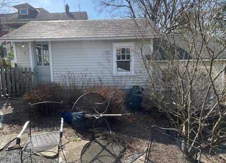 side of house with worn white siding