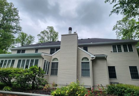 rear exterior of house with painted vinyl siding
