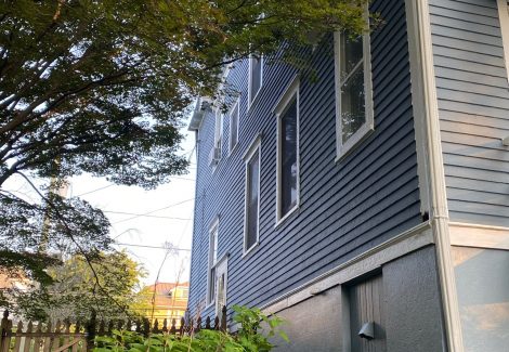 side of house with blue siding and whit trim