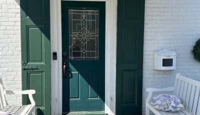 painted green door and shutters on house