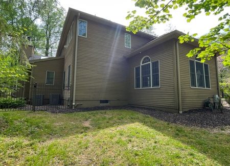 rear exterior of house with brown siding