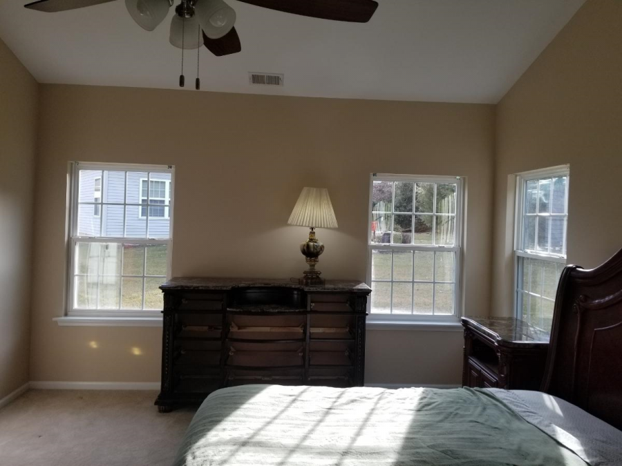 tan painted master bedroom walls with white painted ceiling and trim