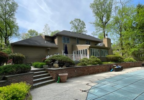 rear exterior of house with brown siding