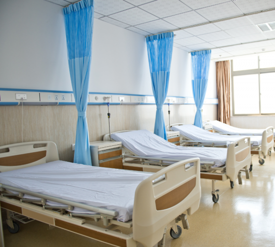 hospital beds lined up in healthcare facility