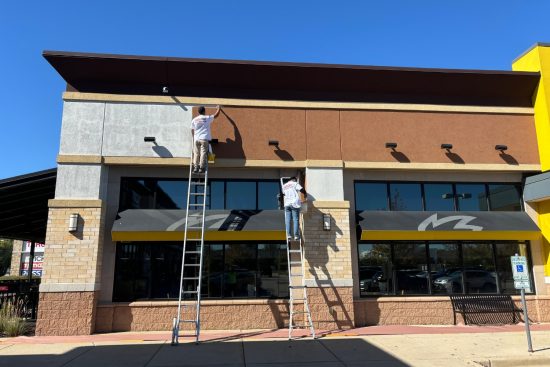 Retail Shops Case Study during photo men on ladders painting building