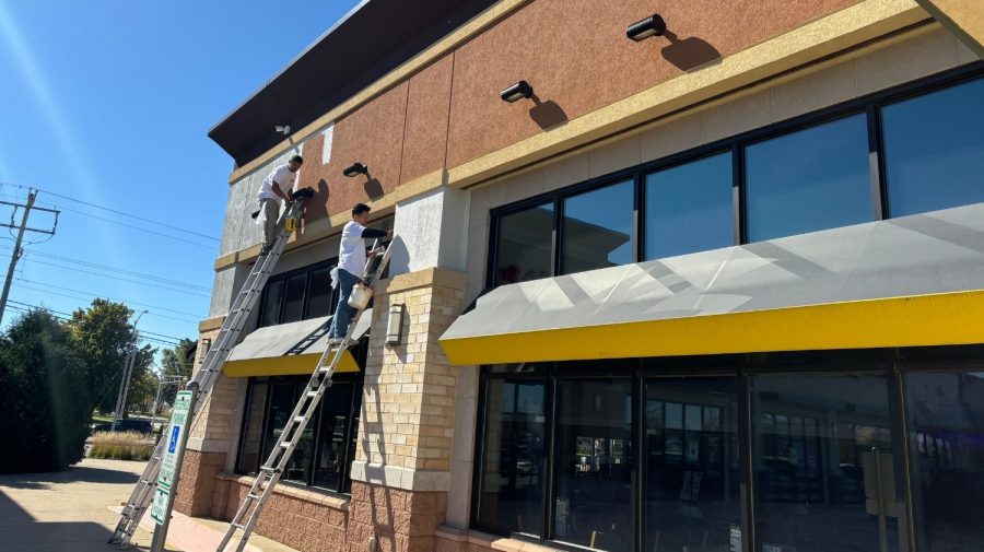 Retail Shops Case Study during photo men working on ladders painting around sign Preview Image 9