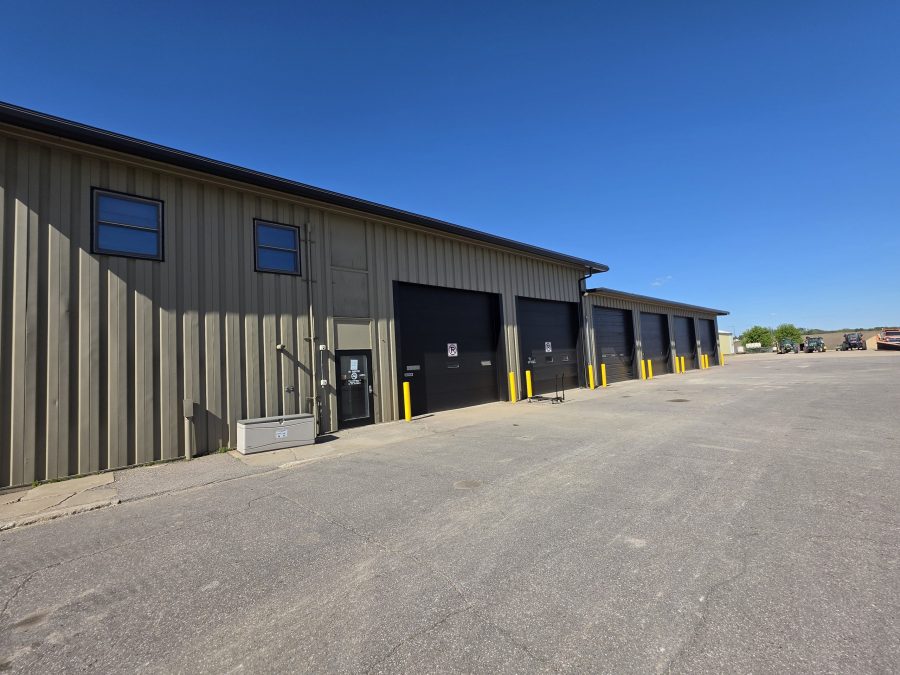 grey khaki paint job done on commercial warehouse building with large black garage doors in Le Center, Minnesota. Preview Image 1