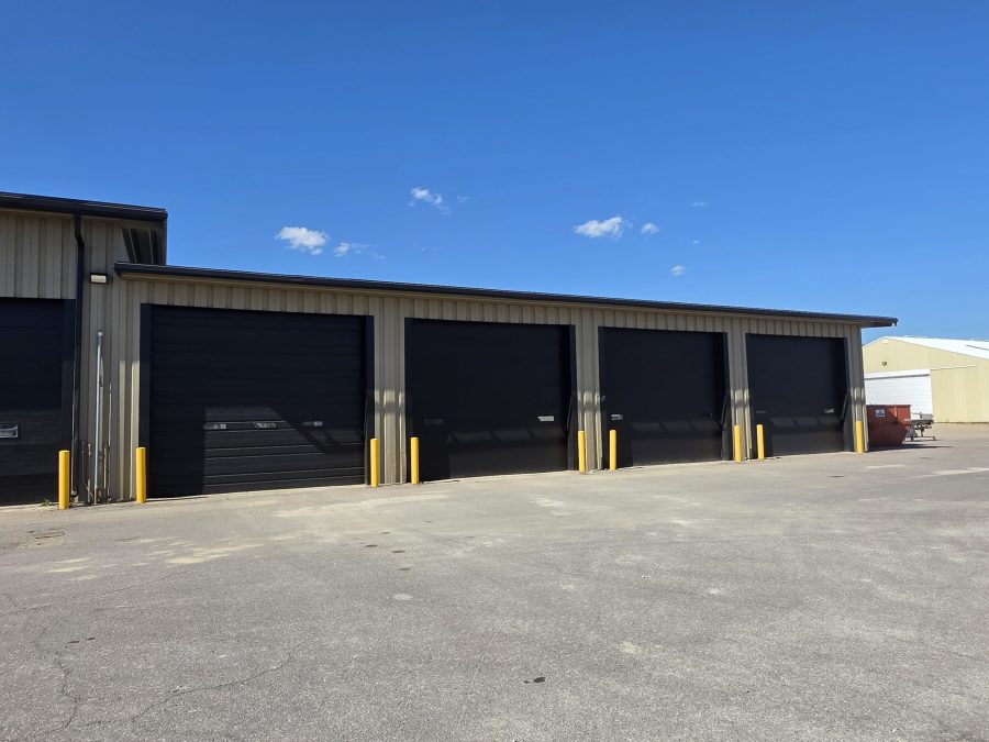 grey khaki paint job done on commercial warehouse building with large black garage doors in Le Center, Minnesota. Preview Image 2