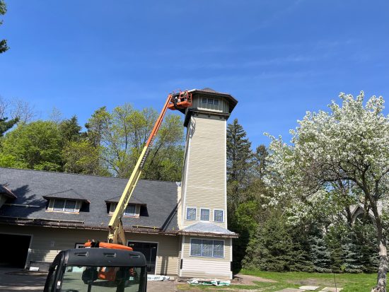 Bucket lift being utilized to paint at elevation