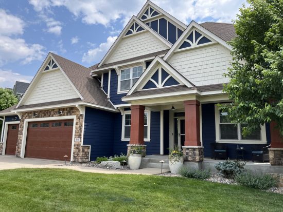 Blue and red house exterior with newly painted siding and trim CertaPro