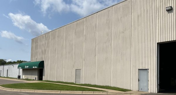 stained and discolored wall of jh larson distribution prior to exterior painting