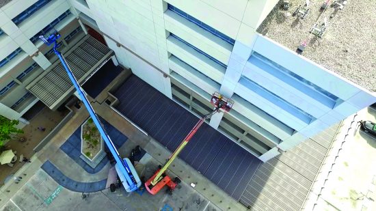 exterior parking garage painting with boom lift