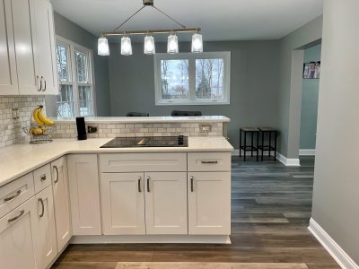 kitchen with cabinets with grey walls and wood flooring