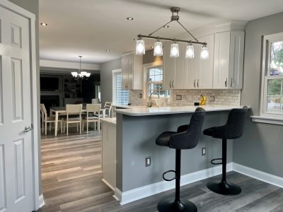 kitchen with white cabinets, grey walls, and wood flooring