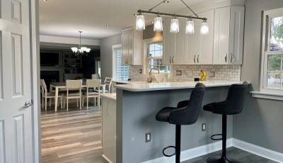 kitchen with white cabinets, grey walls, and wood flooring
