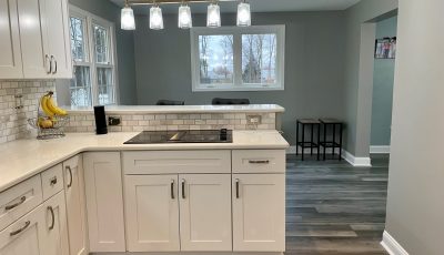 kitchen with cabinets with grey walls and wood flooring