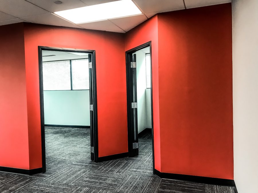 Red walls and two doorways in office complex interior after completed painting project by CertaPro Mount Laurel Preview Image 2