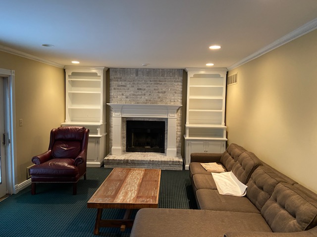 Repainted family room with white bookshelves and tan color