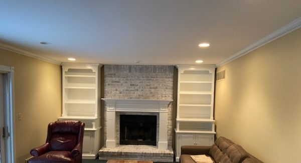 Repainted family room with white bookshelves and tan color