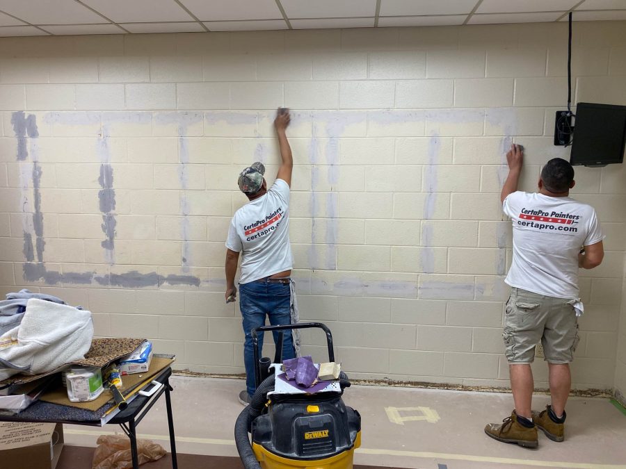 Painters at work painting interior wall Preview Image 2