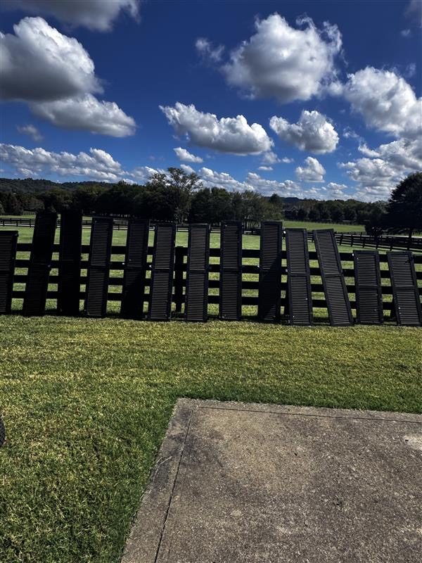 painted shutters drying against fence Preview Image 4
