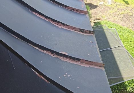 black metal awning with chipping paint